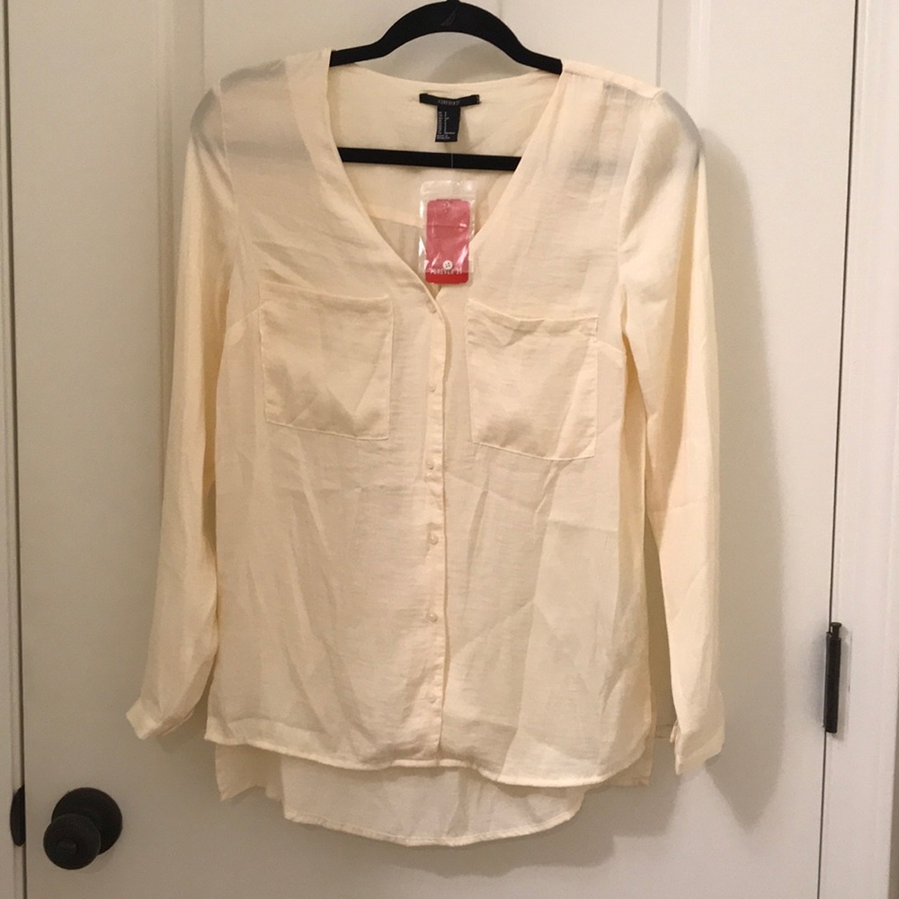 Cream colored silky long sleeve blouse